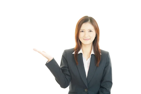 Business woman showing something on the palm of her hand — Stock Photo, Image