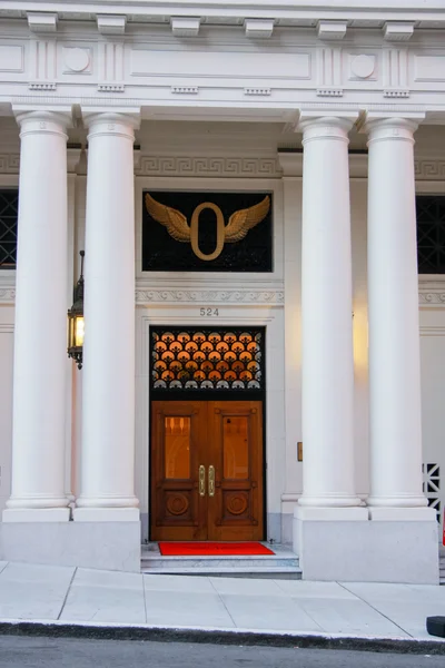 Front wooden door of classical building with four pillars — Stock Photo, Image