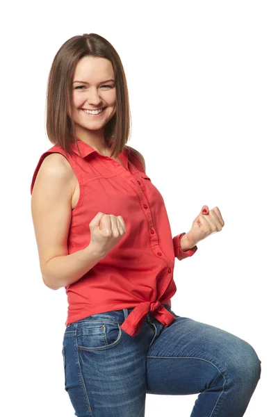 Pretty brunette in blue jeans and a red shirt on white background — Stock Photo, Image