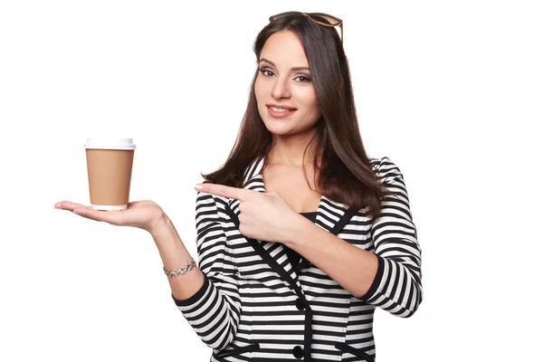 Happy Woman in Stripe Jacket Points Out to the Cup of Coffee. Isolated — Stock Photo, Image