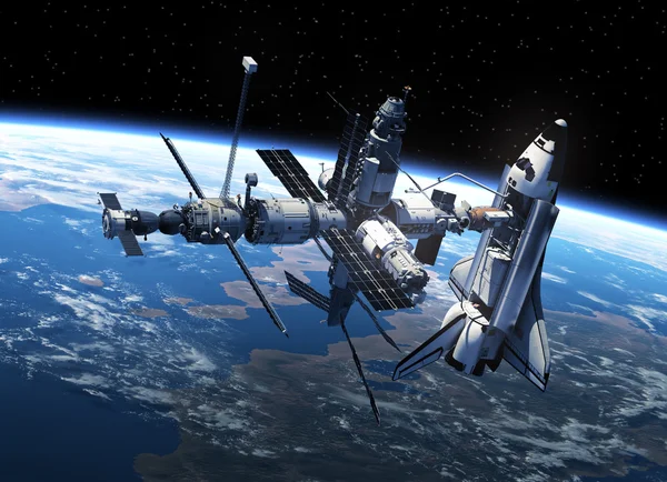 Transbordador espacial y estación espacial en el espacio Imagen de archivo