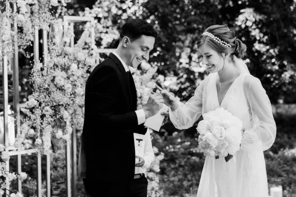 beautiful wedding ceremony. wedding arch on the background of the groom with nesty. happy newlyweds at the ceremony. visiting ceremony. a beautiful couple.