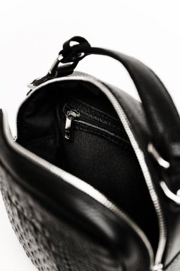 women's handbag in black on a white background. details of a female leather bitch. crocodile skin texture. bag for a business lady. exclusive handbag