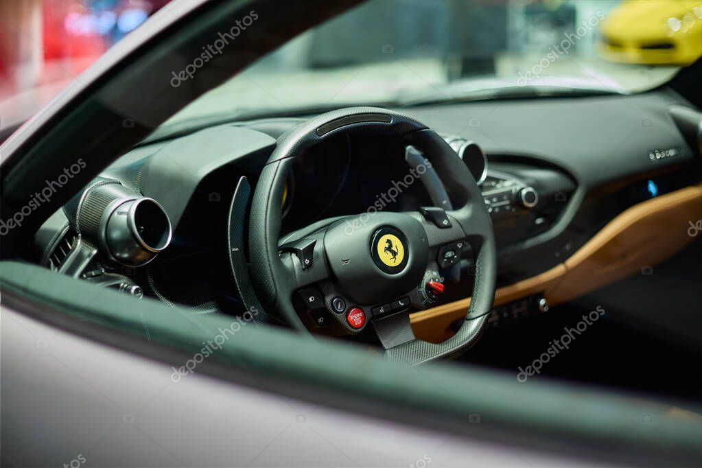 Steering wheel and interior Ferrari F8 Tributo Spider. view through the car window. Katowice, Poland, 29.10.2019