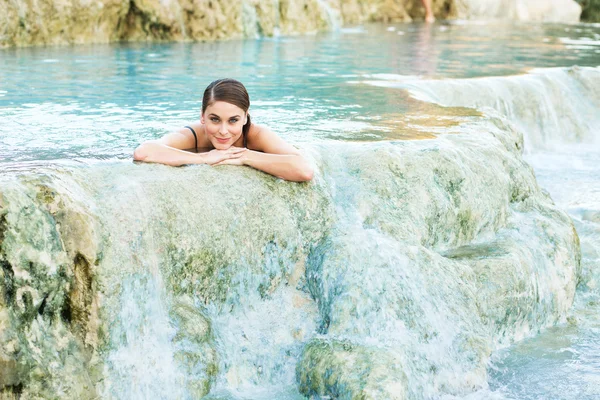 Giovane donna sdraiata nella piscina naturale, Saturnia, Italia — Foto Stock