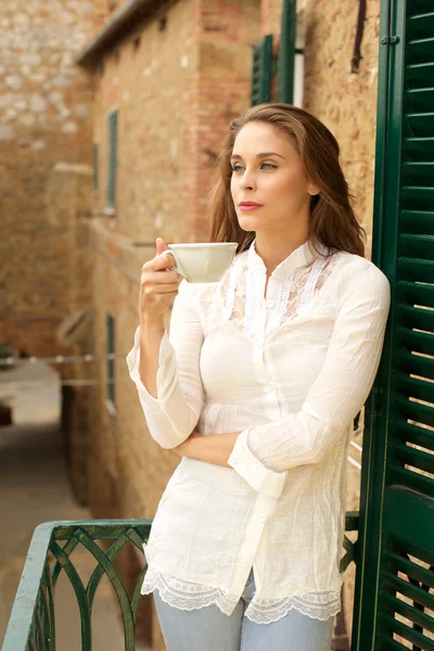 Portrait of happy young woman with cup of hot beverage — Stock Photo, Image