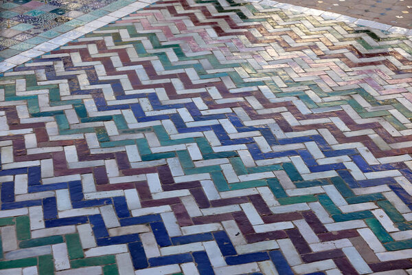 Colorful ceramic tiles form a beautiful, intricate pattern on the floor at a ceramics school in Fez, Morocco. This workspace reflects the region's rich artistic heritage and craftsmanship