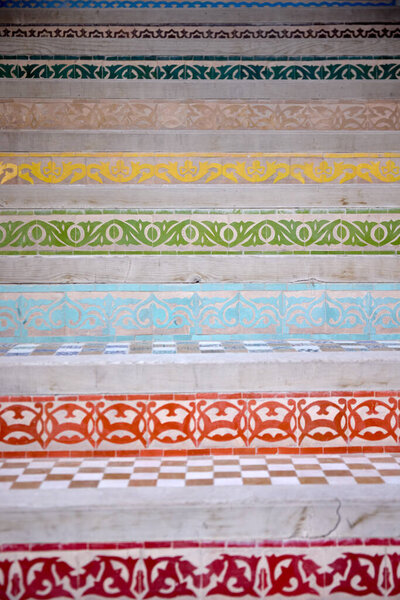 Colorful ceramic tiles adorn the steps of a ceramics school in Fez, Morocco. Each step showcases unique patterns, reflecting traditional craftsmanship and artistry