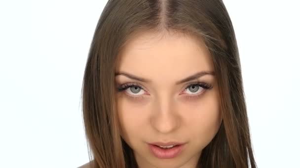 Face closeup of the girl on a white background, slow motion 100fps — Stock Video