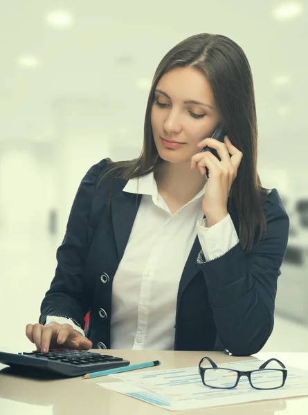 Secretary talking by smartphone in office — Stock Photo, Image