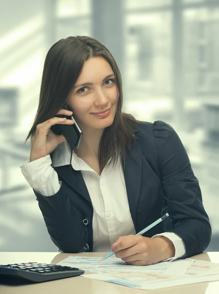 Secretary talking by smartphone in office — Stock Photo, Image