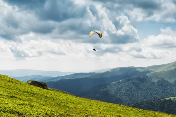 Paisagem com nuvens nas montanhas, parapente, paraquedas, planador Fotos De Bancos De Imagens