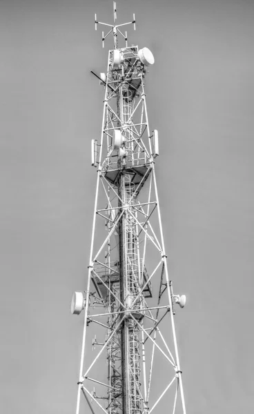 Communication antenna tower on black and white
