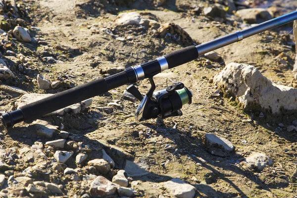 Fishing rod on the ground — Stock Photo, Image
