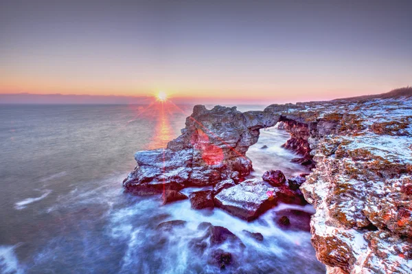 Colorful sunrise over the sea and rocky shore — Stock Photo, Image