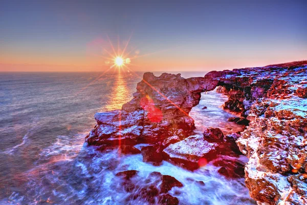 Lever de soleil coloré sur la mer et le rivage rocheux — Photo