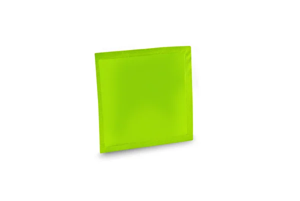 Green condom isolated — Stock Photo, Image