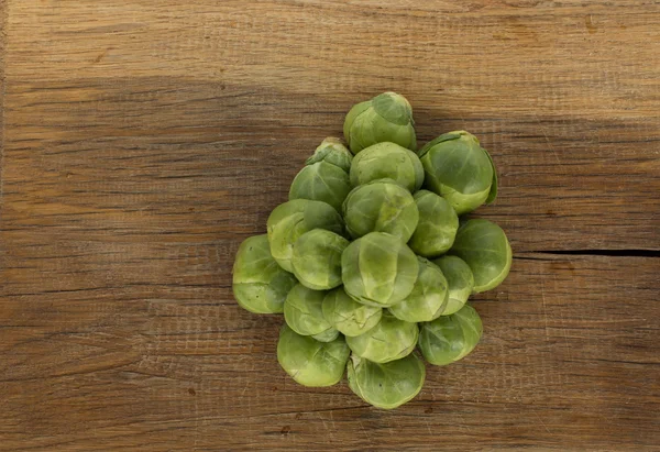 Brussel sprouts on a wooden board — Stock Photo, Image