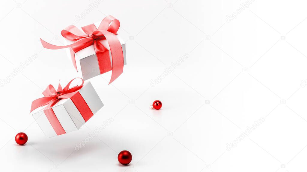 Holiday Christmas background. White gift box with red ribbon, New Year balls in xmas composition on white background for greeting card. Copy space. Winter holidays, New Year