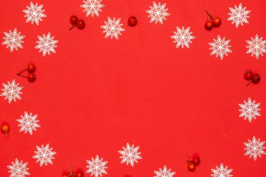 Noel kompozisyonu. Kırmızı böğürtlen, beyaz kar taneleri kırmızı zemin üzerinde tebrik kartı için. Düz konum, üst görünüm, kopyalama alanı