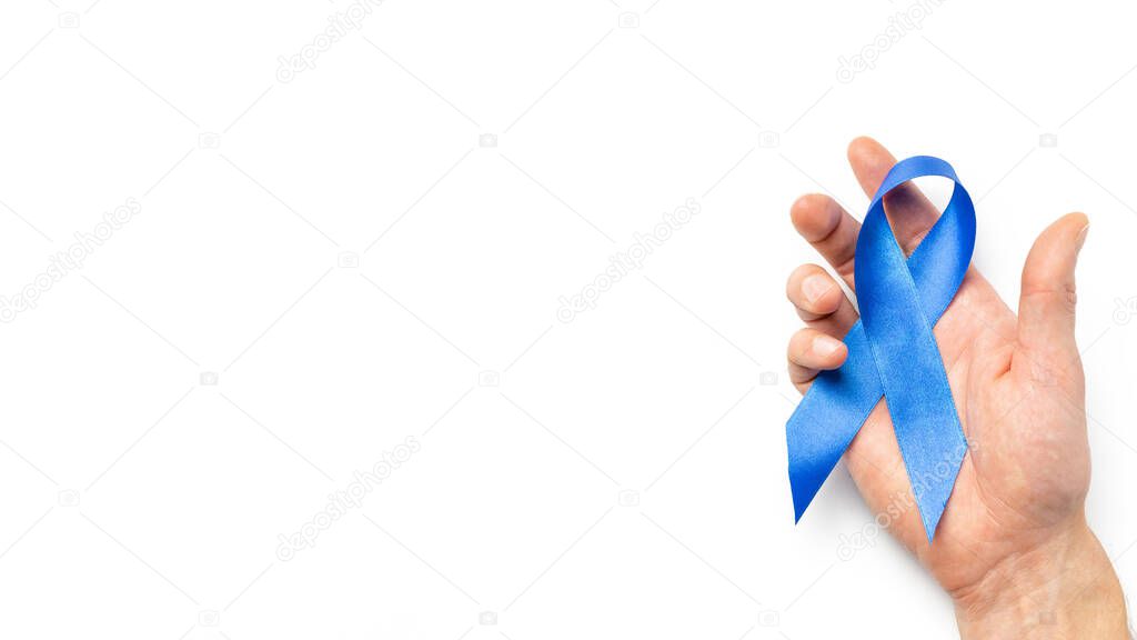 Blue prostate ribbon. Awareness prostate cancer of men health in November. Blue ribbon in hands isolated on white background. November and International Mens Day