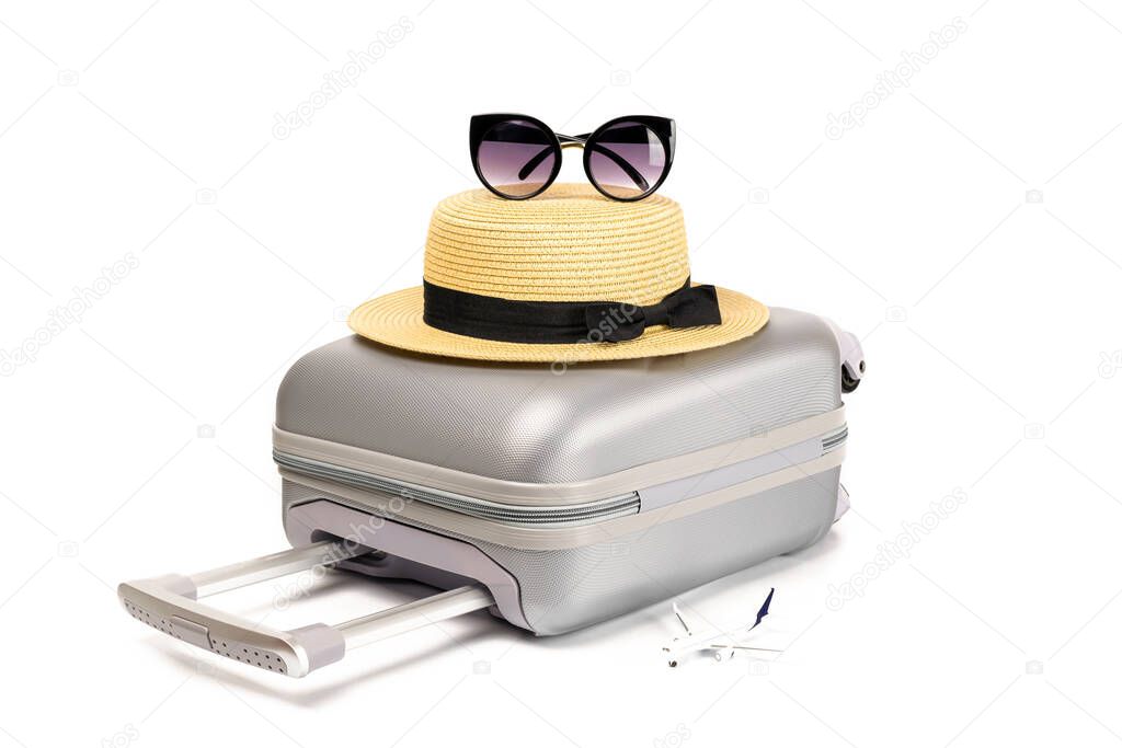 Summer holiday poster. Womens accessories traveler: suitcase, straw hat, sunglasses and toy plane isolated on white background with empty space for text. Summer product advertisement concept