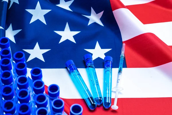 Vaccine usa isolated. Medical syringe with needle for protection flu virus and coronavirus. Covid immunization on american flag background. Concept fight against virus covid-19