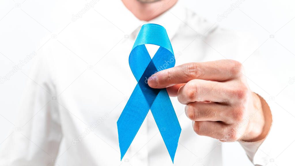 Prostate care. Awareness prostate of men health in November. Hipster men in bright shirt with blue ribbon in hands on white background. World cancer day and world diabetes day concept