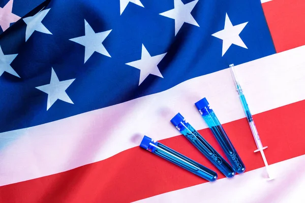 Vaccine usa isolated. Medical syringe with needle for protection flu virus and coronavirus. Covid immunization on american flag background. Concept fight against virus covid-19