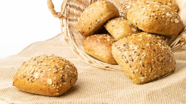 Çavdar ekmeği izole. Kabuklu somun ve ekmek kırıntılarıyla fırın. Buğday tohumu kulaklı bir somun taze ekmek ya da doğal pamuk arka planında çivili bitki. Biyolojik malzemeler, tohumlarla sağlıklı.