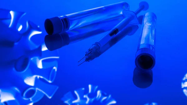 Virus protection. Medical syringe with needle for protection flu virus and coronavirus. Covid vaccine isolated on blue. Syringe, medical injection