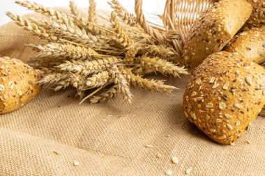 Dilimlenmiş Multigrain. Çavdar ekmeği ve ekmek kırıntılarıyla. Buğday tohumu kulaklı bir somun taze ekmek ya da doğal pamuk arka planında çivili bitki. Biyolojik malzemeler, çok sağlıklı.