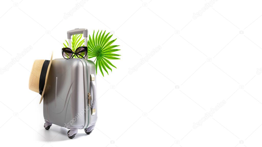 Summer time. Travel accessories with suitcase, straw hat, palm leaves in minimal trip vacation concept isolated on white background. Exotic tropical beach with copy space