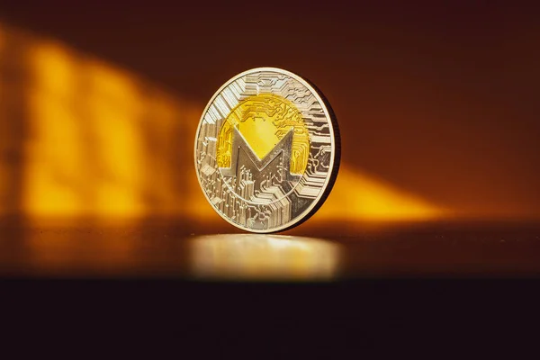 Monero icon. Gold Crypto currency BTC Bitcoin on black background. Golden Bit Coin virtual cryptocurrency or blockchain technology. Trading on the cryptocurrency exchange