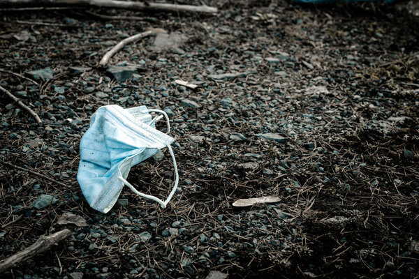 Trash rubbish waste, medical mask in environment. Plastic garbage in forest woodland. Ecological problem with Empty used bottles of big city