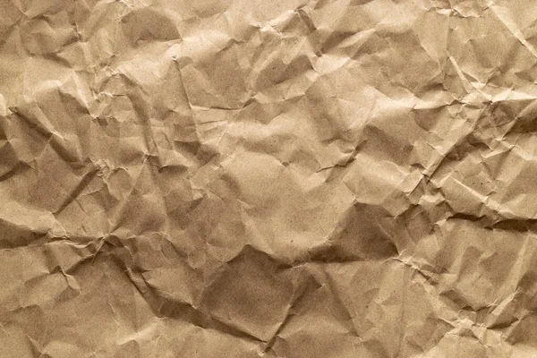 Wrinkled craft paper. Torn kraft paper texture background. Old craft vintage cardboard isolated on black. Recycled material concept