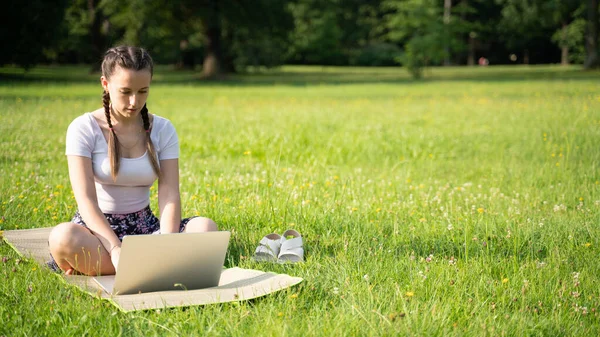 Laptop outdoor business technology. Student girl person work on tablet, computer in summer park. Online woman in nature outside. Happy hipster young distance learning concept