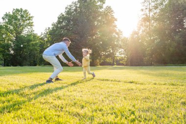 Ebeveynlik dışarıda. Mutlu baba ve küçük kız parkta