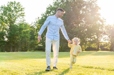 Park zamanı. Ebeveynler ve çocuklar dışarıda kaliteli zaman geçiriyorlar.