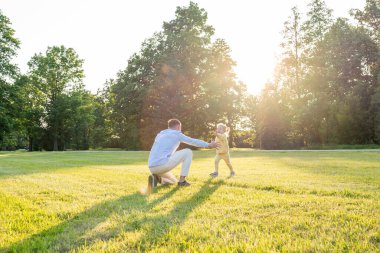 Ebeveynlik dışarıda. Mutlu baba ve küçük kız parkta
