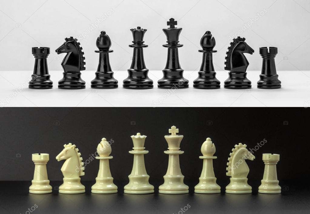 White and Black chess figures isolated on black and white background. Black and White Chess pieces are lined up. Set of chess figures.