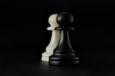 Satranç. Siyah arka plan üzerine siyah ve beyaz piyon. Piyonlar, piyade satranç.