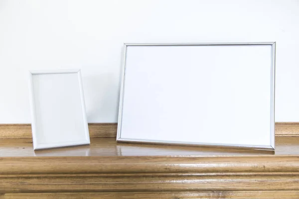 Boş fotoğraf çerçeveleri ahşap şöminenin önünde duruyor.