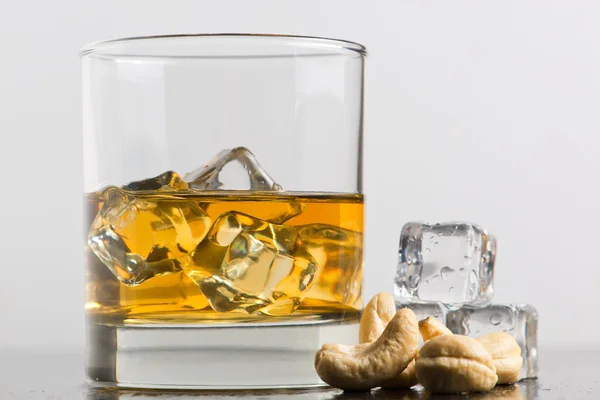 Whiskey with nuts — Stock Photo, Image