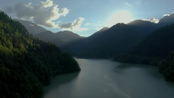 Aerial video filming. Wildlife. View from above. No people. Sunset. Lake Ritsa. Sideways movement. — Stockvideo