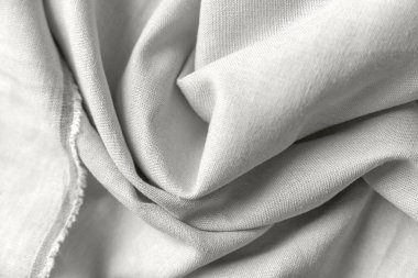 Keten kumaşların beyaz renklerde desenli kumaşları. Tekstil arka planı, üst görünüm. Organik kumaş.
