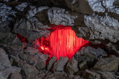 Entrance to ice cave with plenty of icicles. Slope of the mountain inside a fantastic cave. Kungur In The Urals, Russia clipart