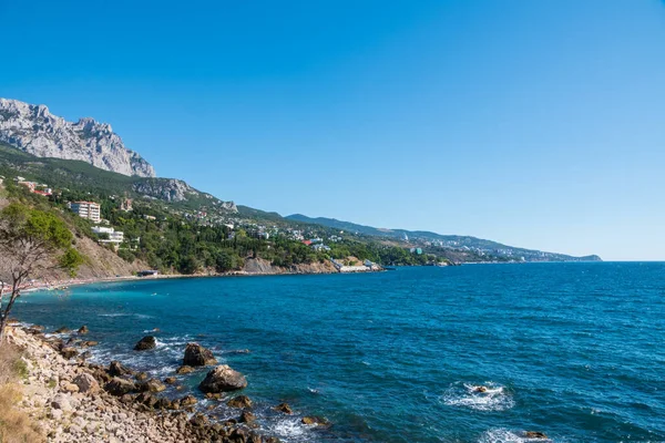 View of the sea and cliffs. Tourism in the Crimea. Summer photo of a sea landscape. Crimean Mountains and sea near town of Alupka, Crimea.