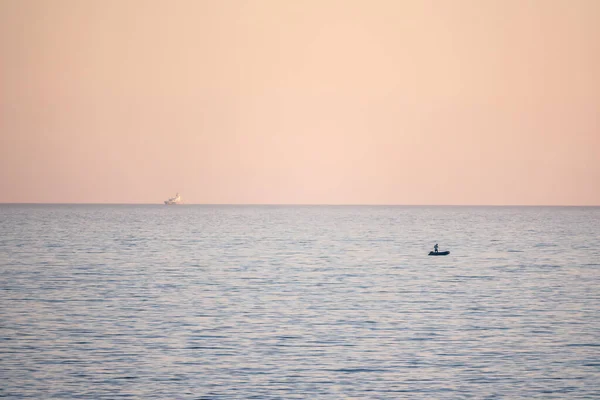 Beautiful pink sunset over the sea in a cloudy sky. Sochi, Russia