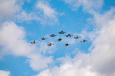 Moskova, Rusya - 5 Mayıs 2021: Savaşçılar Su-35S ve Su-30SM, taktik kanat grubuyla Kızıl Meydan üzerinde mavi gökyüzünde Su-34 bombardıman uçaklarıyla birlikte. Moskova 'daki Zafer Günü geçit töreninin havacılık kısmı. Su-34 bombardıman uçağı gurubu Fullback, Su-35